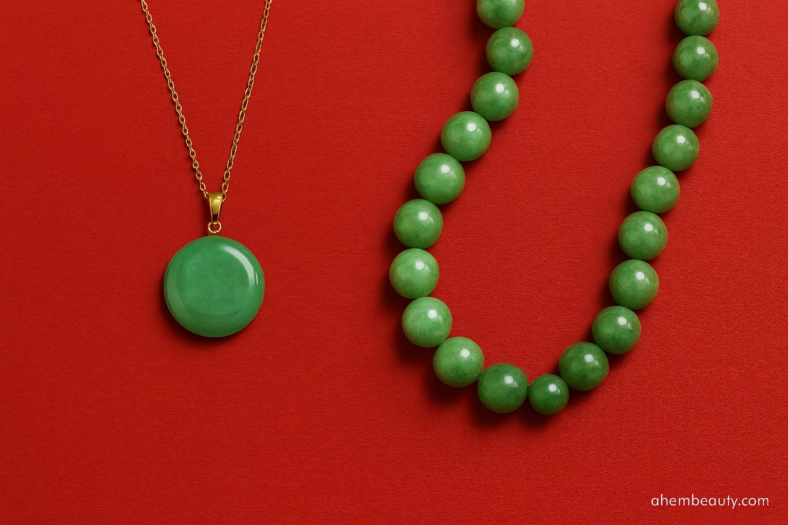Green jade pendant necklace against a red #EC253F editorial backdrop; polished oval jade set in sterling silver; authenticity inspected; women’s heirloom-worthy jewelry; AhemBeauty editorial