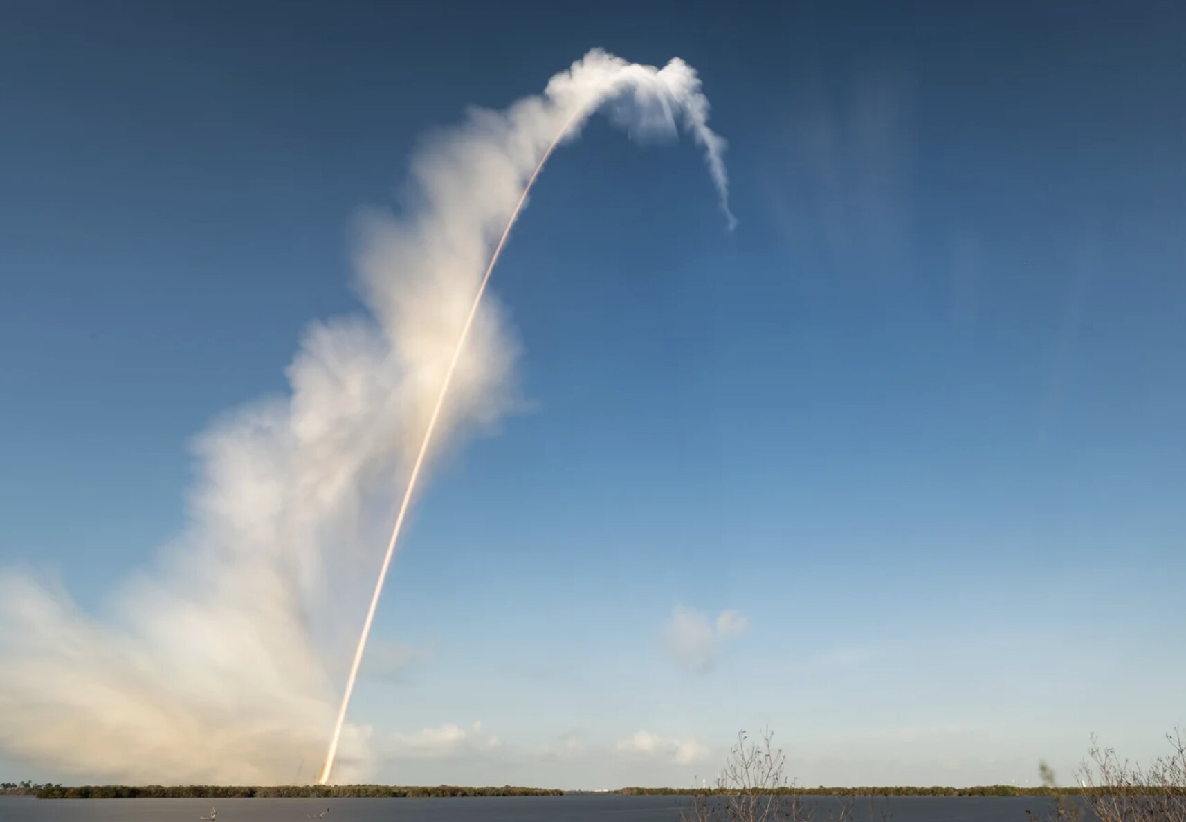 Artemis II rocket launch long exposure image with dust trail at Kennedy Space Center, editorial photo for illustrative news coverage